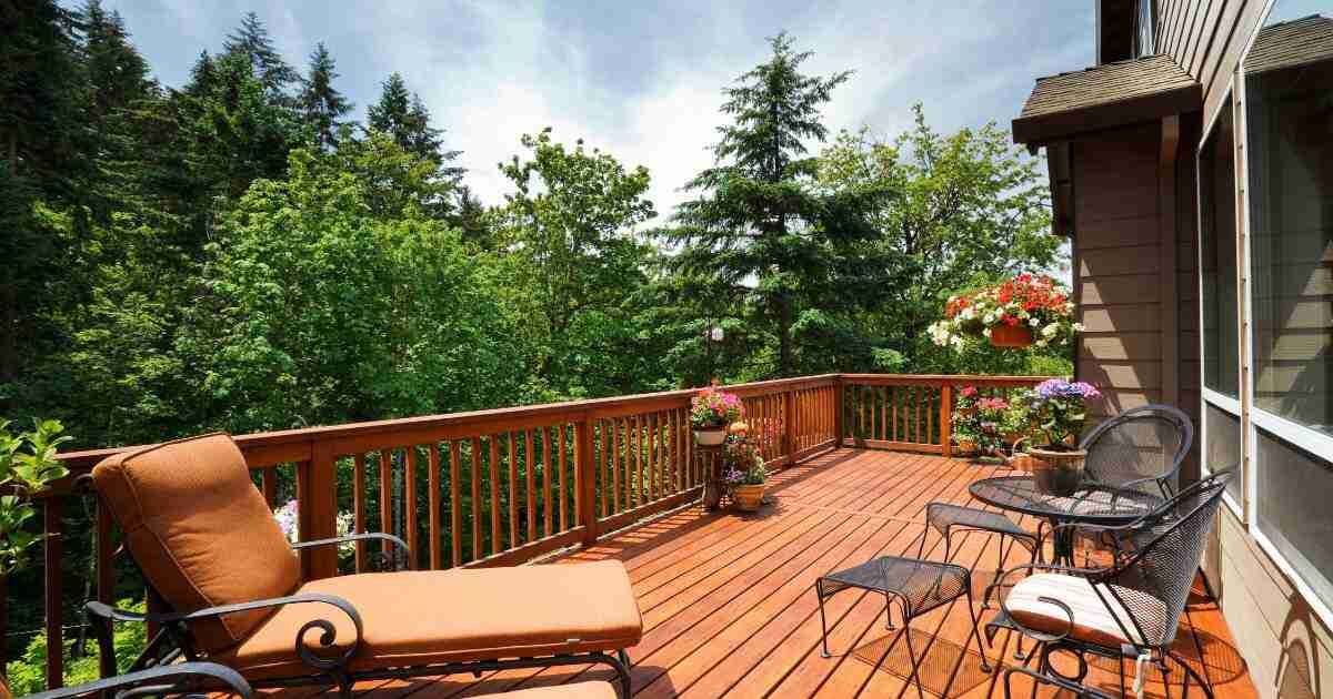 large backyard wood stained deck with furniture 