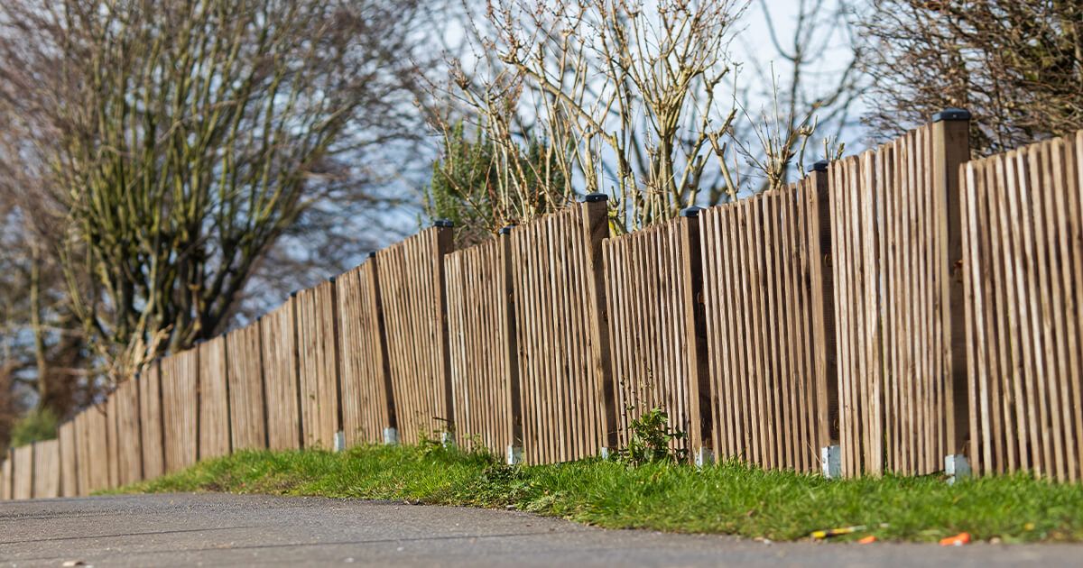 Residential wooden fence beside road.